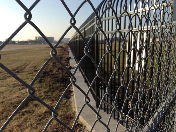 Grey chain link fence is installed around the farm.