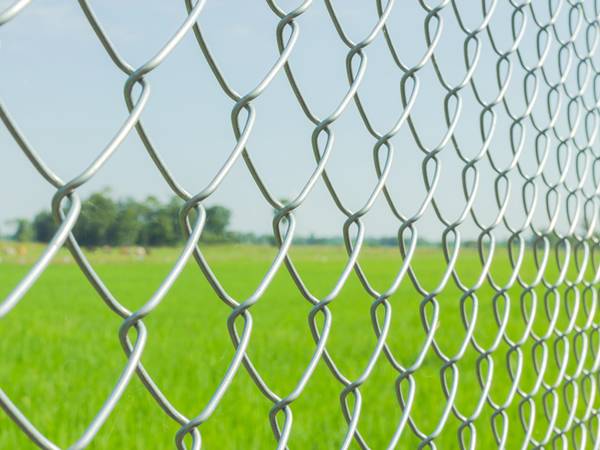 A close up picture of white chain link fence.