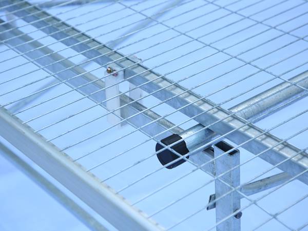 Greenhouse rolling bench top made of welded wire mesh.